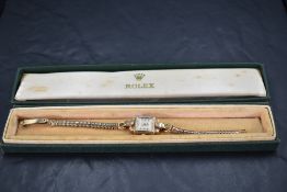 A lady's 1950's 9ct gold Rolex wrist watch having Arabic numeral dial to square face in 9ct gold