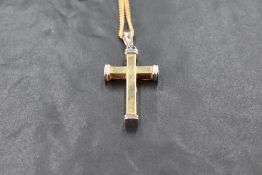 A 9ct white and yellow gold cross pendant on a 9ct gold curb chain, approx 18' & 11g gross