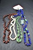 A string of cultured pearls retailed in Hong Kong, a string of tigers eye beads a mixed string