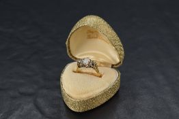 An 18ct gold diamond and opal ring, the central oval opal within six small diamond brilliants