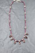 A rough cut amethyst necklace having collared garnet drops and white metal bead spacers, approx 16'