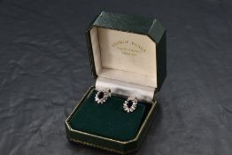 A pair of 18ct white gold sapphire and diamond earrings having oval sapphires, each approx 1.1ct