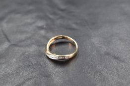 A diamond chip set 9ct gold half eternity ring of curved form, size L/M, approx 2.1g