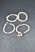 Four single strand baroque pearl bracelets