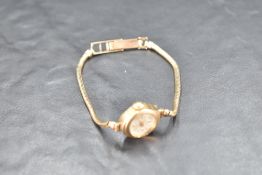 A lady's vintage 9ct gold wrist watch by Accurist having baton & Arabic numeral dial to small face