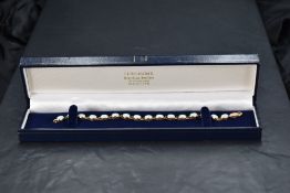 A 9ct gold and opal tennis bracelet, having sixteen oval links each set with an oval opal cabochon