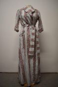 A 1950s crisp cotton floral house coat, with 3/4 sleeves with turn up cuffs, wide tie belt to