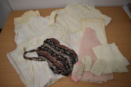 A collection of vintage and antique baby clothing and a child's 1950s shirred swimsuit.