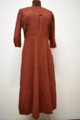 A russet wool late 1030s/early 1940s day dress, having 3/4 sleeves and press stud fastening to