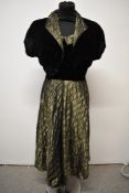 A late 1940s/early 1950s evening dress and bolero of olive flocked taffeta and velvet.