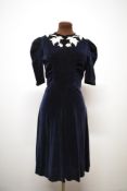 A 1930s midnight blue velvet dress, having cream satin appliqué leaf design to neckline, gathers