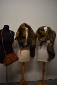 Two 1940s silver fox wraps and a tan leather shoulder bag.