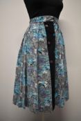 A 1950s cotton novelty print skirt, having wonderful transport pattern with horses, cars and