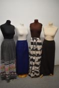 Four vintage maxi skirts, including two with floral designs.