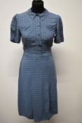 A 1940s blue checked day dress, having pockets with turn over detail to front of bodice and button