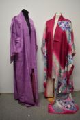 Two vintage Kimonos, both having vibrant designs.