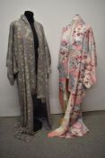 Two vintage Kimonos, in pink and lilac hues, both having floral detailing.