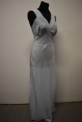 A 1930s American bias cut blue nightdress having pink floral applique to gathered cross over bust,