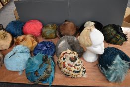 A variety of vintage feather hats, various sizes, eras and styles, around nineteen in total.