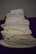An assortment of antique and vintage damask and double damask table linen, some good sized table