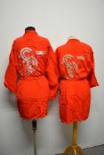 Two vintage red kimono dressing gowns, having machine embroidered designs to both.