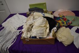 A miscellany of vintage and antique items, amongst which are aprons, tea cosies, shawls, collars,