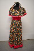 A vibrant 1960s cotton or cotton blend maxi dress, with amazing shawl collar, ruffled hem and rear