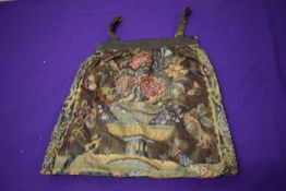 An early 20th century bag, having floral pattern and metallic thread to handles and frame.