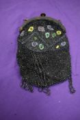 A 1920s/30s beaded bag, having tortoiseshell effect frame, void of strap, lining damaged.