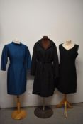Three vintage 1960s dresses, including teal blue shift dress with 3/4 sleeves and bow to neckline.
