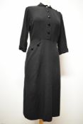 A late 1940s/ early 1950s black medium weight cotton day dress, having button accent to sleeve and