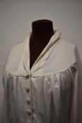 An early 1940s wedding dress having self covered buttons to slightly blouson bodice and sleeves,
