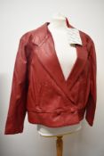 A dead stock 1980s red leather jacket, with tags.