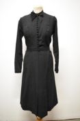 A 1940s black cotton day dress, having full length sleeves, pleated skirt with vents to front,
