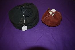 Two Art Deco draw string evening bags, one of black suede and the other wine coloured suede.