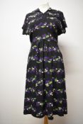 A 1940s novelty print crepe day dress, having pleats to bodice, smocking to waist and wonderful