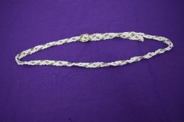 A vintage white and silver beaded belt.