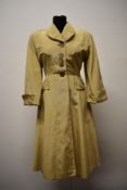 A 1940s cream grosgrain fitted coat, having buttons to front and faux pockets, half belt to back and