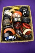 A basket full of mixed vintage and modern bangles, predominantly plastic, many colours and styles.