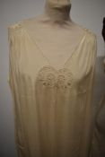 A 1920s cream nightdress with cut work and scalloped detailing, A slip with lace edging and an earl