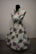 A 1950s cotton day dress and matching bolero jacket, having novelty abstract atomic style print,