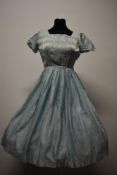 A 1950s striped day dress in duck egg blue with scoop neckline, cap sleeves and pleated skirt.