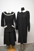 A 1940s black wool two piece outfit, comprising belted top with pique collar and braid detailing