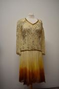 A 1950s/60s crepe Art Deco style dress, having long sleeves, drop waist and bead work throughout,