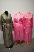An oriental pyjama set, comprising pyjamas and a dressing gown, sold with a brightly patterned house