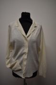 A late 1950s cream cardigan, 'Bellmans Scotch wool shop' label to nape, medium size.