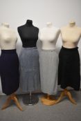 Three 1940s and 1950s skirts, including grey with colourful fleck and pleat to reverse with button