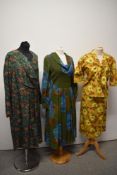 A 1950s cotton two piece outfit in autumnal tones, a 1950s green and brown day dress and a 1960s