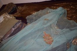 A shoe box containing an assortment of vintage fabrics and sections, including metallic thread