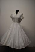A 1940s medium weight white linen day dress, having cap sleeves, side metal zip and fairly full
